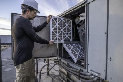 Hvac Service Technician Inspecting Equipment